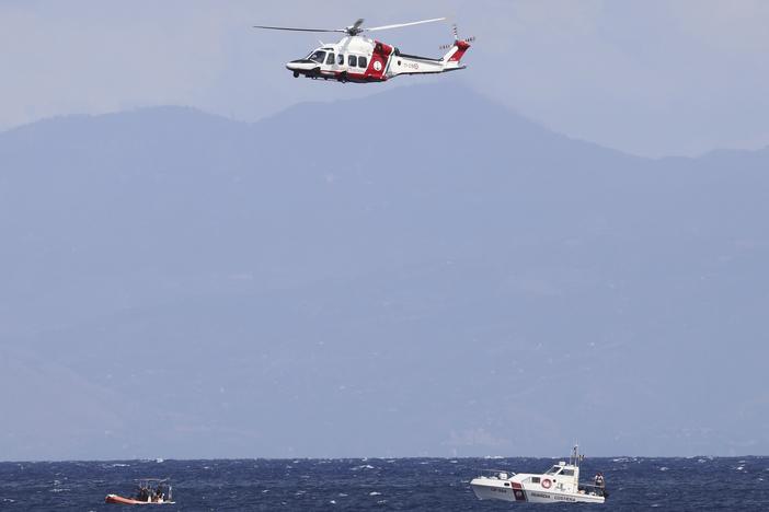 Emergency services at the scene of the search for a missing boat Monday in Porticello Santa Flavia, Italy. 