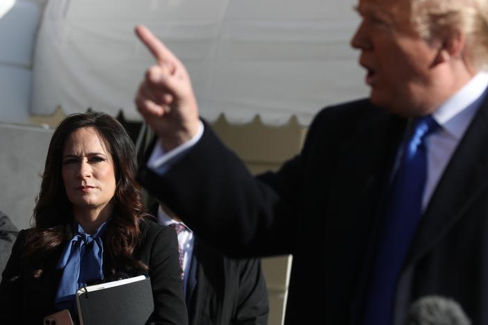 Then-White House Press Secretary Stephanie Grisham (L) listens to U.S. President Donald Trump talk to reporters, November 08, 2019 in Washington, DC.
