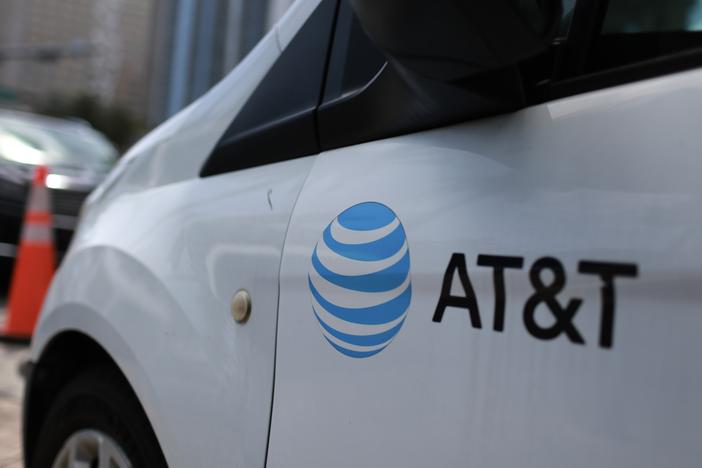 An AT&T logo adorns a worker's van on April 1 in Miami, Fla.