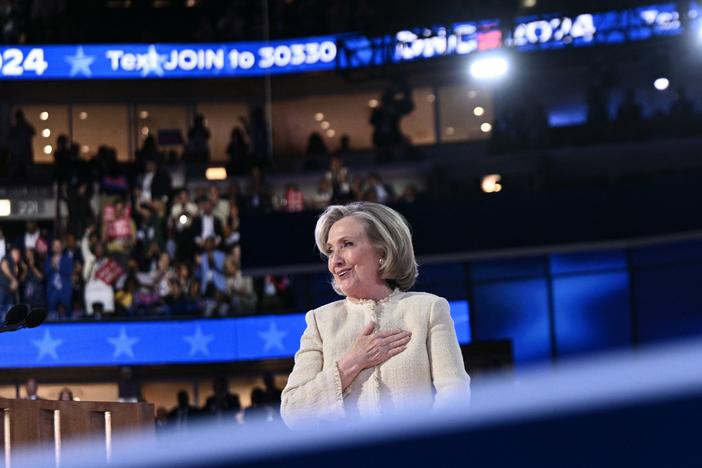 Former US Secretary of State Hillary Clinton salutes the attendees as she steps off stage after speaking on the first day of the Democratic National Convention.