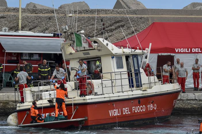 Italian firefighter divers bring ashore in a green bag the body of one of the victims of the U.K.-flag vessel Bayesian on Wednesday. The luxury sail yacht was hit by a violent sudden storm and sunk early Monday, while at anchor off the Sicilian village of Porticello near Palermo, in southern Italy.