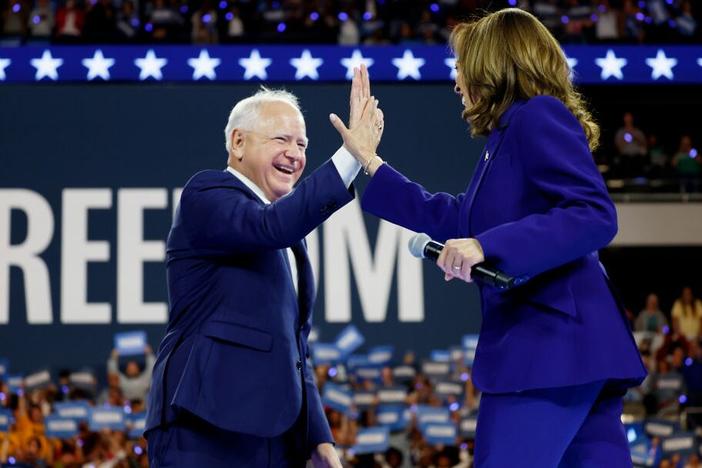 Democratic vice presidential candidate and Minnesota Gov. Tim Walz high-fives presidential nominee Kamala Harris at a campaign rally at the Fiserv Forum on Tuesday in Milwaukee. 