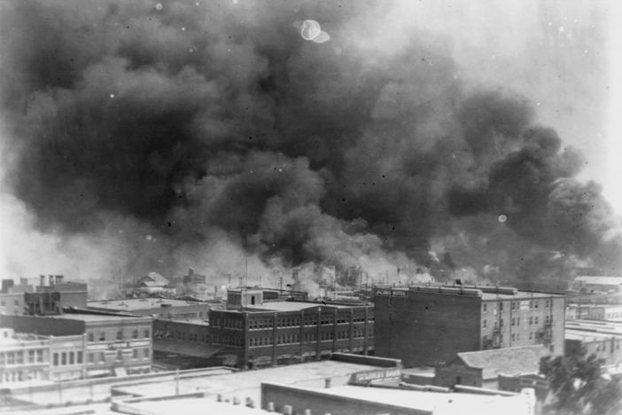 In this 1921 image provided by the Library of Congress, smoke billows over Tulsa, Okla. 