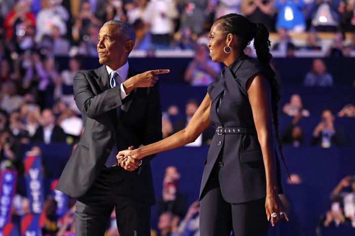 Former First Lady Michelle Obama (R) introduces former President Barack Obama on the second day of the Democratic National Convention at the United Center in Chicago, Illinois, on August 20, 2024. 
