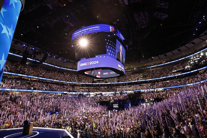Attendees wave "Coach Walz" signs as Minnesota Governor and 2024 Democratic vice presidential candidate Tim Walz speaks on the third day of the Democratic National Convention in Chicago. Tim Walz formally accepted his nomination to be the Democratic Party's vice presidential candidate in a keynote address on August 21 at the party's convention, calling it "the honor of my life."