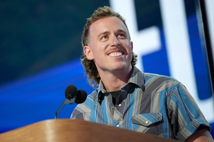 Content creator John Russell speaks on stage during the final day of the DNC in Chicago. 