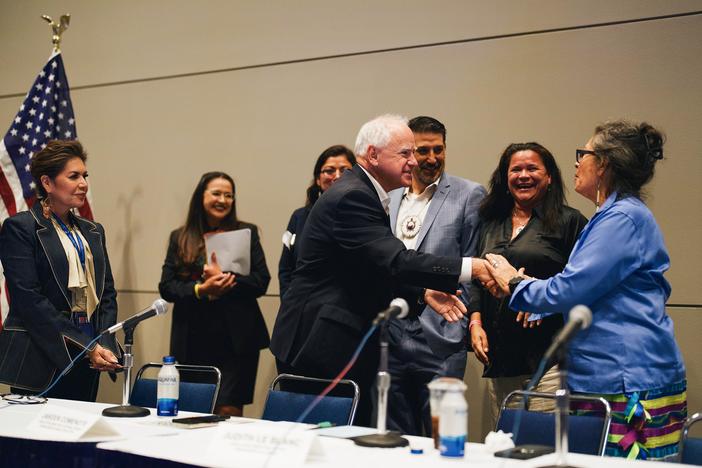Vice Presidential candidate and Minnesota Gov. Tim Walz shakes hands with panelists during the Native American Caucus meeting at McCormick Place in Chicago on Aug. 19, 2024.