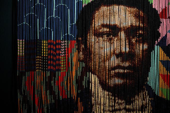 “Wail on Whalers, a Portrait of Amos Haskins” by Felandus Thames, an “homage to escaped enslaved people who found autonomy in whaling,” is comprised of hairbeads strung on coated wire. The piece is part of the “Entwined” exhibition, which reimagines thousands of years of maritime history through Black and Indigenous worldviews and experiences. (Ryan Caron King/Connecticut Public)