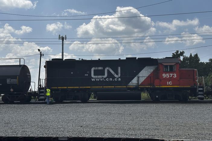 A railwayman inspects the locomotive of a Canadian National Railroad train, Thursday, Aug. 22, 2024 in Metairie, La.
