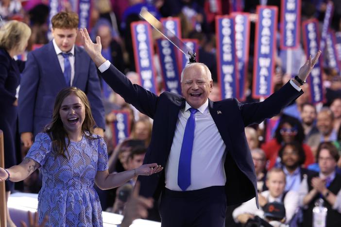 Democratic vice presidential nominee Minnesota Gov. Tim Walz reacts with his daughter Hope Walz after accepting the Democratic vice presidential nomination on stage during the third day of the Democratic National Convention.