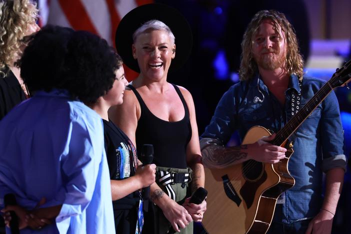 Musician Pink, her daughter Willow Sage Hart (2nd L) and guitarist Justin Derrico (R) take part in stage testing ahead of the start of the final day of the Democratic National Convention.