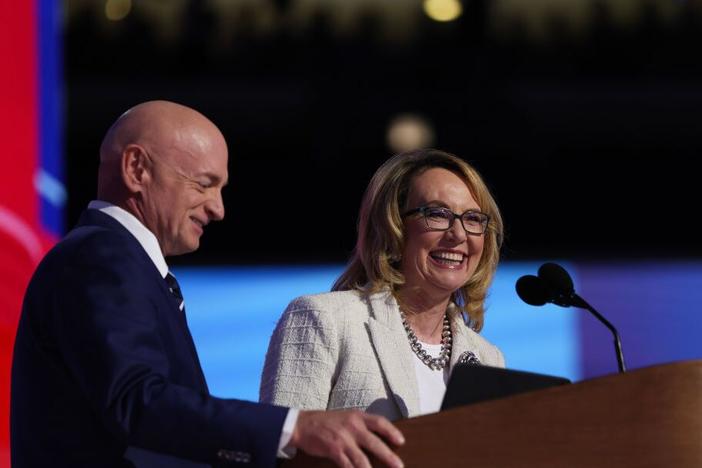 Gun control advocate and former U.S. Rep. Gabby Giffords, D-Arizona, speaks on stage with her husband, U.S. Sen. Mark Kelly, D-Arizona, during the final day of the Democratic National Convention at the United Center on Thursday in Chicago, Illinois. Delegates, politicians, and Democratic Party supporters are gathering in Chicago, as current Vice President Kamala Harris is named her party's presidential nominee. 