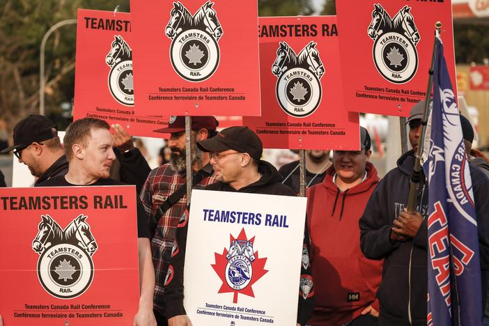 Teamsters Canada Rail Conference members picket outside the CPKC headquarters in Calgary, Alta., on Friday.