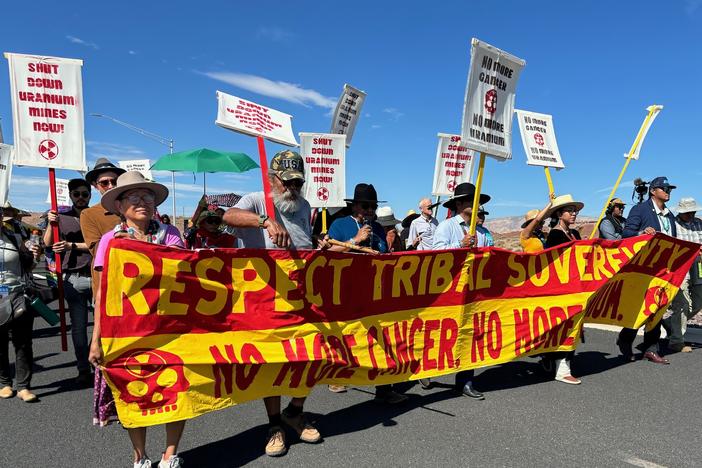 Protestors, led by Navajo Nation President Buu Nygren, marched along Highway 89 in Cameron on Aug. 2, 2024 to protest uranium hauling through the reservation. The highway was part of the route taken by trucks from the Pinyon Plain Mine near the South Rim of the Grand Canyon three days earlier when they began uranium ore transportation through a large swath of the nation.