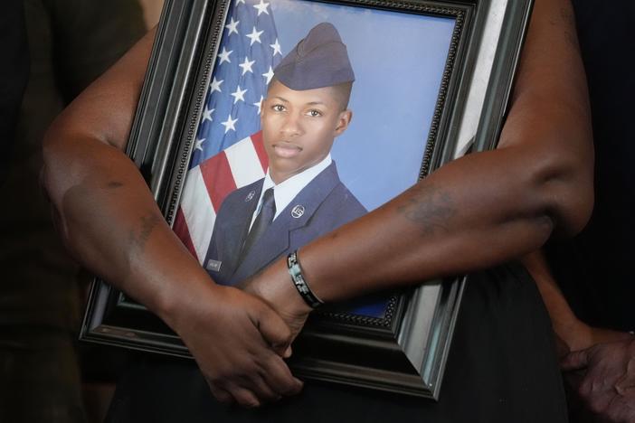 Chantemekki Fortson, mother of slain Roger Fortson, a U.S. Air Force senior airman, holds a photo of her son during a news conference with attorney Ben Crump on June 3, 2024, in Atlanta.