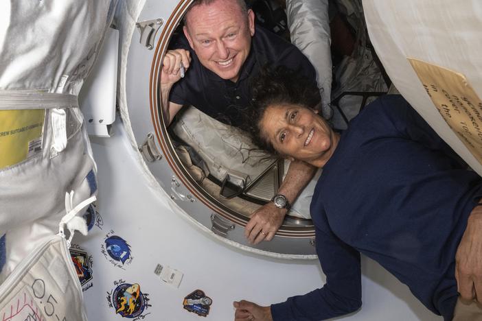 In this photo provided by NASA, Boeing Crew Flight Test astronauts Butch Wilmore (left) and Suni Williams pose for a portrait inside the vestibule between the forward port on the International Space Station's Harmony module and Boeing's Starliner spacecraft on June 13.  