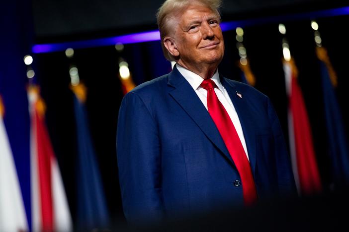 Republican presidential nominee and former President Donald Trump smiles at a crowd in Detroit on Monday.