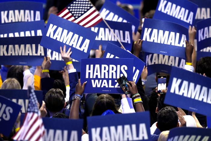 Supporters carry signs as Democratic presidential nominee Vice President Kamala Harris speaks during the Democratic National Convention on Aug. 22 in Chicago.