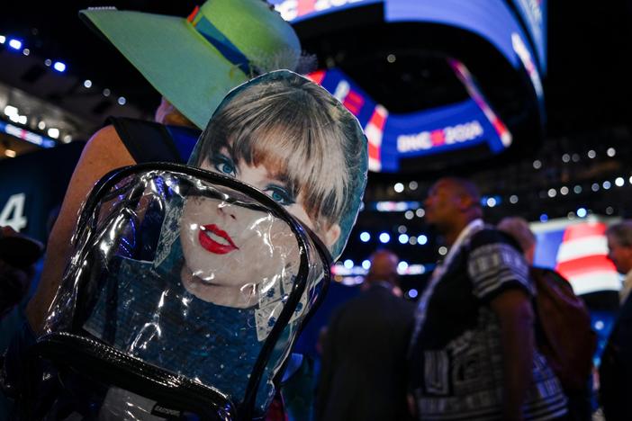An attendee wears a backpack with a Taylor Swift sign during the third day of the Democratic National Convention in Chicago. Swifties for Kamala, a grassroots group not affiliated either with Swift or the Harris campaign, raised more than $140,000 for the Democratic presidential nominee after a call Tuesday night.