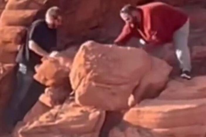 An image provided by the National Park Service shows two men who were caught on video in April toppling rock formations at Lake Mead National Recreation Area. A federal jury has indicted Wyatt Clifford Fain, 37, and Payden David Guy Cosper, 31, of Henderson, Nev.