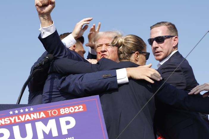 Former President Donald Trump is rushed offstage during a rally on July 13, 2024 in Butler, Pa., after an attempted assassination.
