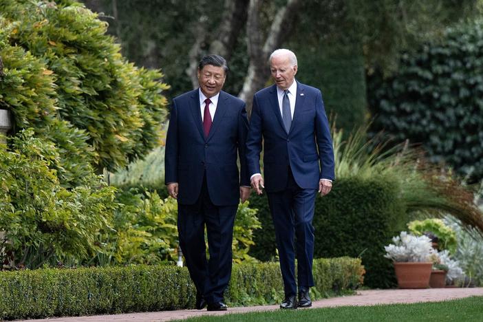  US President Joe Biden (R) and Chinese President Xi Jinping walk together after a meeting in California last November.  White House officials say that meeting has led to better cooperation on fentanyl interdiction, but some experts are skeptical.