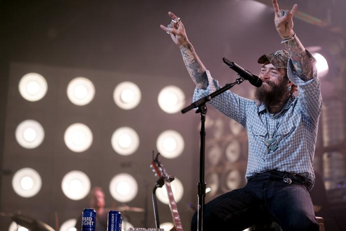 Post Malone, who has spent the year shifting his focus from hip-hop and pop toward country music (scoring a No. 1 single in the process) performs on July 16, 2024, in Nashville, Tenn. His first all-country album, <em>F-1 Trillion</em>, topped this week's <em>Billboard</em> album chart.