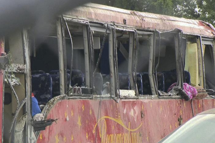 A damaged bus is shown after several people were killed and dozens injured after the commercial bus overturned on Interstate 20 early Saturday in Warren County, Miss., according to the Mississippi Highway Patrol. 