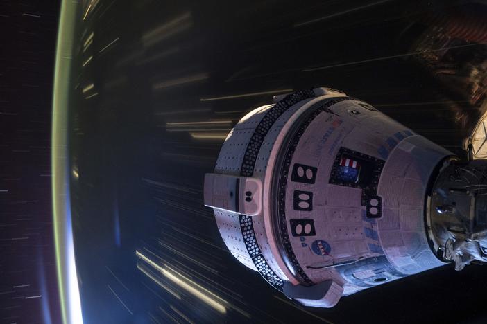 In this long-exposure photo provided by NASA, Boeing's Starliner spacecraft is docked to the Harmony module of the International Space Station on July 3.