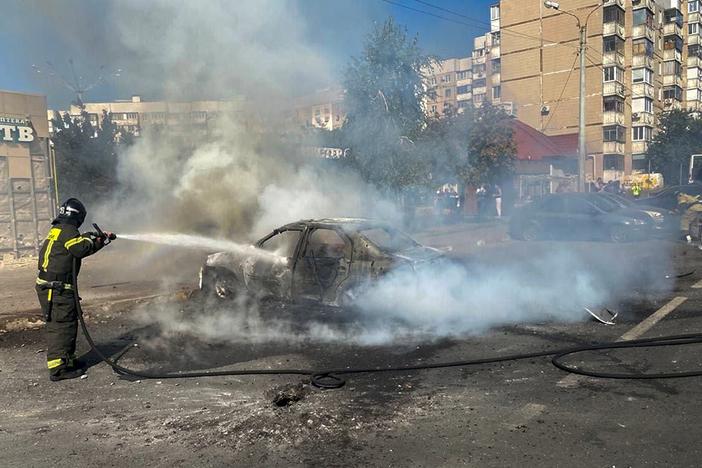 In this photo released by Belgorod regional governor Vyacheslav Gladkov's Telegram channel on Sunday, Sept. 1, 2024, firefighters extinguish a burning car in the courtyard of an apartment building after a missile attack by the Armed Forces of Ukraine on the city of Belgorod and the Belgorod region of Russia.