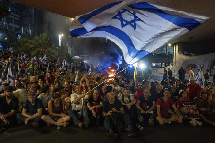 People block a road as they protest, calling for a deal for the immediate release of hostages held in the Gaza Strip by Hamas, in Tel Aviv, Israel, Sunday, Sept. 1, 2024.