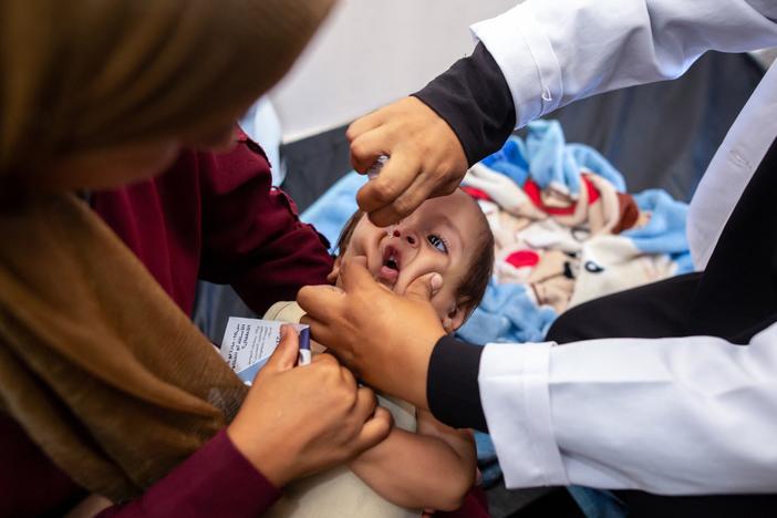 A nurse administers polio vaccine drops to a young Palestinian patient at the Nasser hospital in Khan Yunis in the southern Gaza Strip on Saturday amid the ongoing conflict between Israel and the Hamas militant group. 