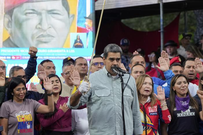 Venezuelan President Nicolás Maduro brandishes a sword as his new Cabinet takes the oath of office, at the presidential palace in Caracas, Venezuela, Aug. 28.
