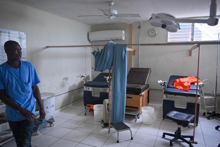 A hospital worker shows the damage inside Fontaine Hospital in Port-au-Prince, Haiti, three days after an armed attack forced its closure last fall.