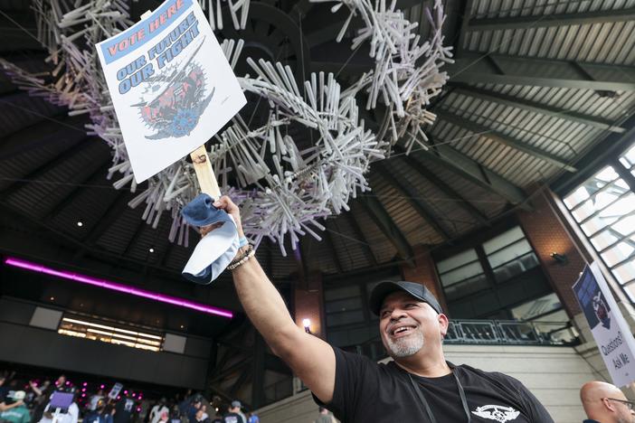 Manny Briones, an iron machinist from Seattle, welcomes members and supporters of the International Association of Machinists and Aerospace Worker Union District 751 for an early strike-sanction vote at T-Mobile Park in Seattle on July 17.
