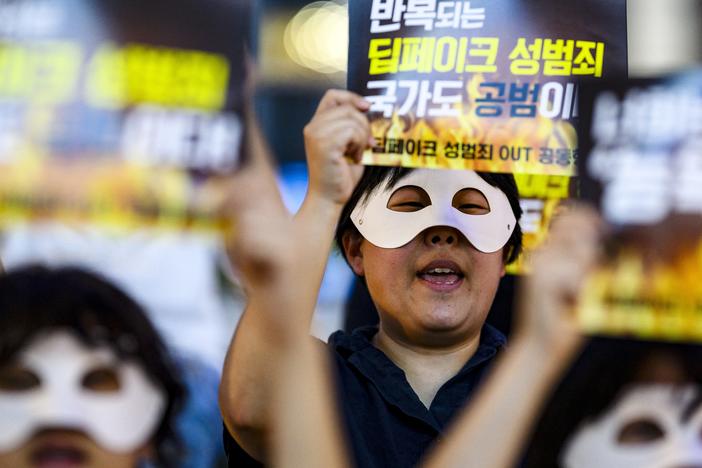 Activists wearing eye masks hold posters reading "Repeated deepfake sex crimes, the state is an accomplice too," during a protest against sexually abusive deepfakes in Seoul, South Korea, on Aug. 30.