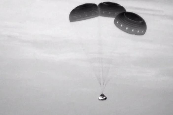  This image, taken from NASA video, shows the Boeing Starliner capsule coming down through the darkness over New Mexico. 