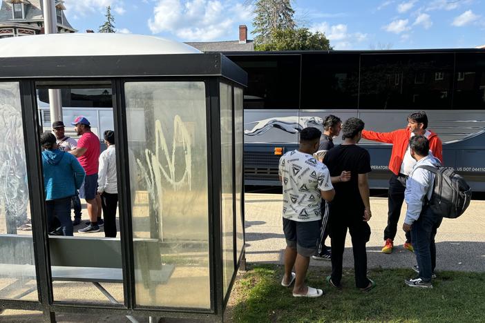 A group of Indian and Haitian immigrants arrive at a bus stop in Plattsburgh, N.Y. on a Saturday afternoon in August. The migrants were received by Indian drivers who take them to New York City for a fee.