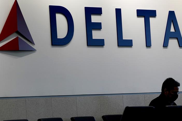 A Delta aircraft clipped the tail of another plane on the tarmac Tuesday morning at Hartsfield-Jackson Atlanta International Airport, officials said. Here, a man is shown waiting for a Delta flight at Hartsfield-Jackson on Jan. 7, 2022. 
