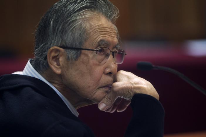Peru's jailed former President Alberto Fujimori, photographed through a glass window, attends his trial at a police base on the outskirts of Lima, Peru, on June 28, 2016. His daughter Keiko Fujimori announced in a post on X that he died of cancer Wednesday. 