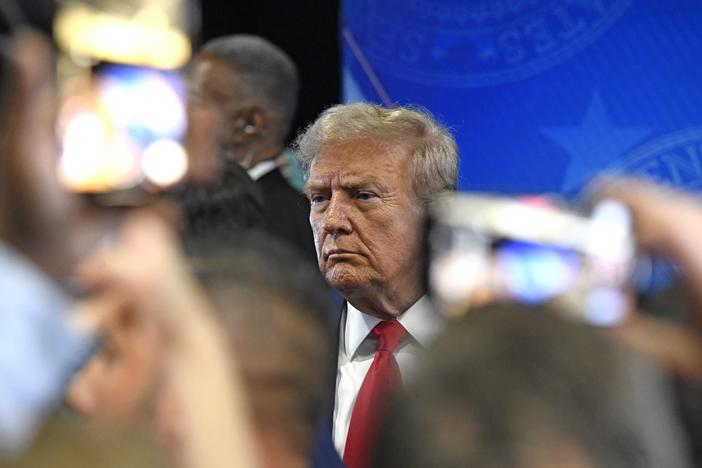 Former President Donald Trump speaks to members of the press following a presidential debate with Vice President Kamala Harris. Shares in his Trump Media company plunged to a record low the morning after the debate.