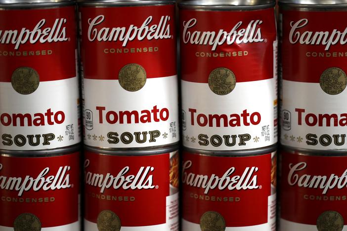 Cans of Campbell's soup are displayed on a shelf at a grocery store in Richmond, Calif., in 2019. The Campbell Soup Company says it's changing its corporate name to The Campbell’s Company.  