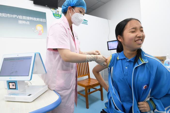 A schoolgirl receives a dose of HPV vaccine at a community health service center in Guiyang, Guizhou province, China.