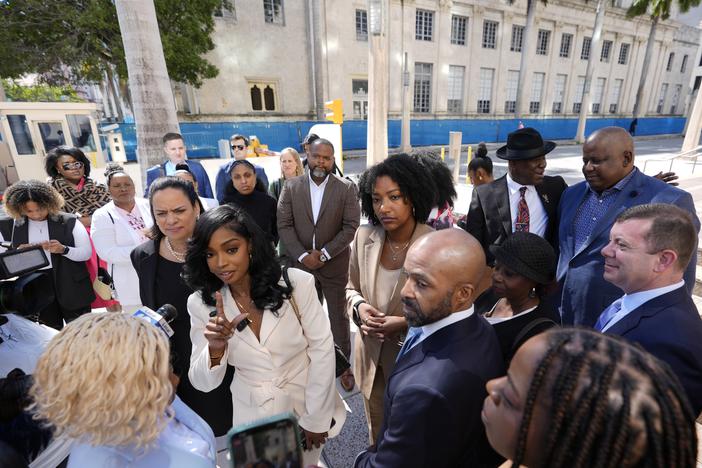 The Fearless Fund, an Atlanta-based venture capital firm, will shutter its grant program for Black women as part of a settlement, ending a year-long affirmative action battle. Here, co-founders and CEOs of The Fearless Fund Arian Simone (center left) and Ayana Parsons (center right) speak to journalists outside federal court in Miami on Jan. 31.