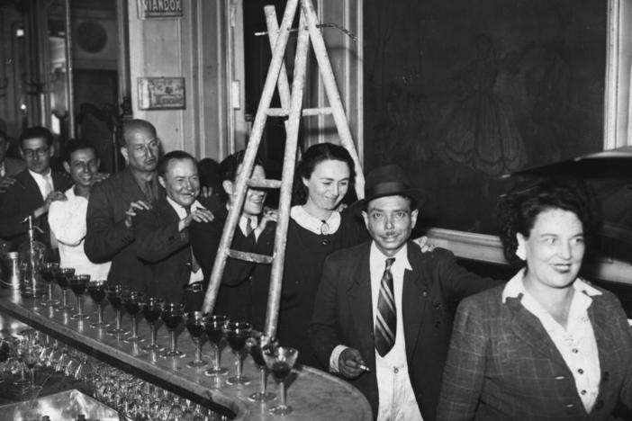 circa 1930: Members of Friday The Thirteenth Club walk under a ladder in single file at a meeting on the outskirts of Paris. The club meets every Friday 13th to do everything that superstitious people traditionally avoid. 