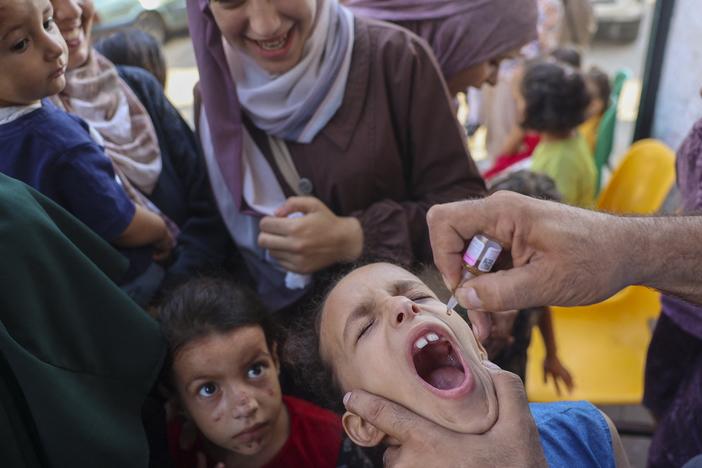 A health worker administers an oral polio vaccine in Zawayda, in the central Gaza Strip. The World Health Organization says that in less than two weeks, they’ve helped administer more than 550,000 polio vaccines to children across the enclave. Now they're gearing up for the second dose.