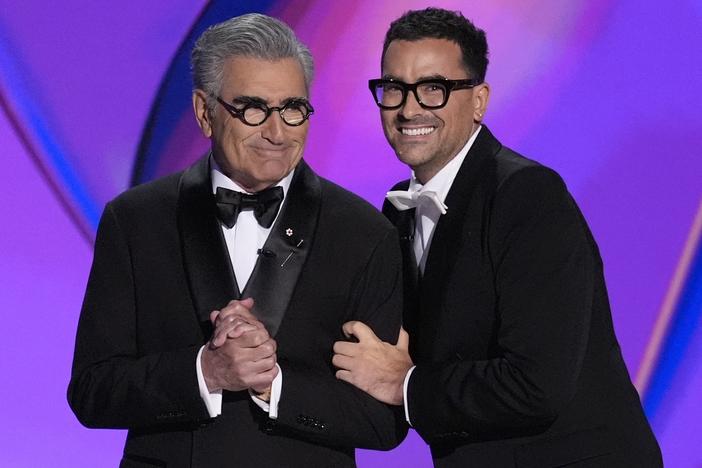 Hosts Eugene Levy and Dan Levy speak during the 76th Primetime Emmy Awards on Sunday at the Peacock Theater in Los Angeles.