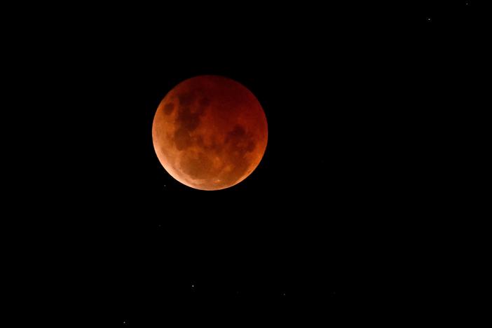 A blood moon is seen during a lunar eclipse on Nov. 8, 2022, over Brisbane, Australia. 