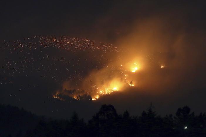 A fire burns on a hillside near Sever do Vouga, a town in northern Portugal that has been surrounded by forest fires, on Tuesday.