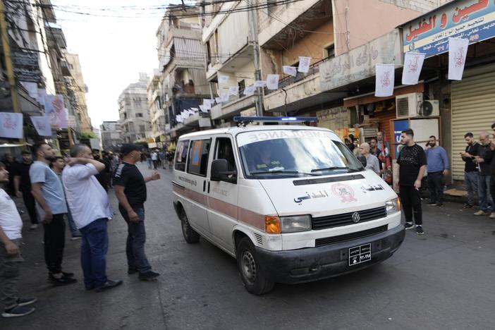 An ambulance believed to be carrying wounded people, after multiple explosions were heard during the funeral of four Hezbollah fighters who were killed Tuesday after their handheld pagers exploded, in a southern suburb of Beirut, Lebanon, Wednesday.